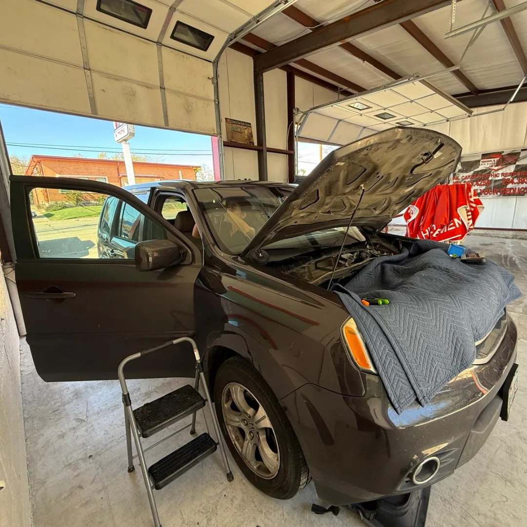 AGC technician replacing a vehicle windshield